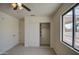 Carpeted bedroom with closet, door, and neighborhood views at 310 N Mountain View Rd, Apache Junction, AZ 85119