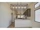 Bright, airy kitchen features gray cabinets, stainless appliances, island sink and pendant lighting at 310 N Mountain View Rd, Apache Junction, AZ 85119