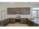 Kitchen featuring gray cabinets, stainless appliances, quartz countertops and stainless faucet at 310 N Mountain View Rd, Apache Junction, AZ 85119