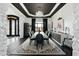 Formal dining room with dark hardwood floors, modern chandelier, and large table perfect for entertaining guests at 3446 E Knoll St, Mesa, AZ 85213