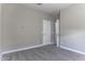 Bedroom featuring neutral walls, plush gray carpeting, and a white door leading to other rooms at 38197 W San Clemente St, Maricopa, AZ 85138