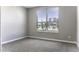 This cozy bedroom has neutral walls, plush carpet, and a window with blinds for natural light at 38197 W San Clemente St, Maricopa, AZ 85138