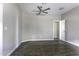 Serene bedroom featuring a ceiling fan and wood-look flooring, perfect for relaxation and comfort at 38197 W San Clemente St, Maricopa, AZ 85138