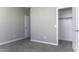 Bedroom with neutral walls, plush carpet, and a closet provides a serene and comfortable space at 38197 W San Clemente St, Maricopa, AZ 85138