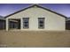 Exterior view of the back of the house with covered patio and windows at 38197 W San Clemente St, Maricopa, AZ 85138