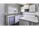 This kitchen features white cabinets, granite countertops, stainless appliances, and a stainless steel sink at 38197 W San Clemente St, Maricopa, AZ 85138