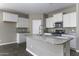 Modern kitchen featuring granite countertops, stainless steel appliances, and a functional center island at 38197 W San Clemente St, Maricopa, AZ 85138