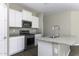 Stylish kitchen showcasing granite countertops, updated appliances, and bright white cabinetry at 38197 W San Clemente St, Maricopa, AZ 85138