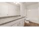 Bathroom featuring granite countertop, white cabinets, and tub-shower combination at 407 E Eason Ave, Buckeye, AZ 85326