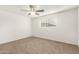 A cozy bedroom with a ceiling fan and carpeted floor at 407 E Eason Ave, Buckeye, AZ 85326