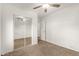 Bedroom with carpet, mirrored closet, and ceiling fan at 407 E Eason Ave, Buckeye, AZ 85326