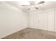 A bright and airy room features a ceiling fan and closet doors at 407 E Eason Ave, Buckeye, AZ 85326