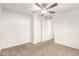 A bright and airy room features a ceiling fan and closet doors at 407 E Eason Ave, Buckeye, AZ 85326