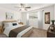 Cozy bedroom featuring a comfortable bed, ceiling fan, and natural light from a window at 407 E Eason Ave, Buckeye, AZ 85326