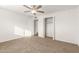 Bedroom with carpet, large window, open closet, and ceiling fan at 407 E Eason Ave, Buckeye, AZ 85326