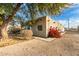 View of the exterior with a blue front door and colorful flowers at 407 E Eason Ave, Buckeye, AZ 85326