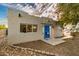 Charming single-story home with a vibrant blue front door and desert landscaping at 407 E Eason Ave, Buckeye, AZ 85326