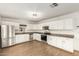 Bright kitchen with stainless steel appliances, white cabinetry and granite countertops at 407 E Eason Ave, Buckeye, AZ 85326