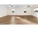 Spacious open-concept living room with sleek wood floors and lots of natural light at 407 E Eason Ave, Buckeye, AZ 85326