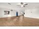 Spacious open-concept living room with sleek wood floors with views into kitchen at 407 E Eason Ave, Buckeye, AZ 85326