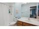 Bathroom featuring a shower with a white shower curtain next to the toilet and sink at 411 W Gascon Rd, San Tan Valley, AZ 85143