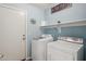 Bright laundry room with modern washer, dryer, and shelving for storage at 411 W Gascon Rd, San Tan Valley, AZ 85143