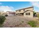 View of the back of the home, showcasing the gravel yard and covered patio area at 4429 W Paseo Way, Laveen, AZ 85339