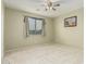 Bedroom featuring a window with curtains, a ceiling fan, and plush carpet at 4429 W Paseo Way, Laveen, AZ 85339