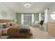 A cozy bedroom showcasing a comfortable bed, natural light from a window, and a stylish dresser at 4429 W Paseo Way, Laveen, AZ 85339