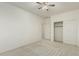 A bedroom featuring plush carpet, a ceiling fan, and a closet with a door at 4429 W Paseo Way, Laveen, AZ 85339