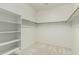 This walk-in closet features built-in shelving and hanging rods to maximize storage at 4429 W Paseo Way, Laveen, AZ 85339