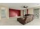 Comfortable living room with a large leather sofa, bright windows, and a sliding glass door at 4429 W Paseo Way, Laveen, AZ 85339