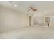 An open loft with neutral carpet, a ceiling fan, and plenty of natural light is perfect for relaxing at 4429 W Paseo Way, Laveen, AZ 85339