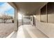 Covered outdoor patio with columns overlooking the rockscaped backyard at 4429 W Paseo Way, Laveen, AZ 85339