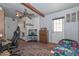 Bedroom with a desk, rug, ceiling fan and an outside door at 4713 W Carol Ave, Glendale, AZ 85302