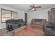 Comfortable living room with hardwood floors, neutral walls, and ample seating space at 4713 W Carol Ave, Glendale, AZ 85302