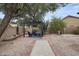 Relaxing backyard patio area with stylish pergola seating, complemented by desert landscaping at 567 W Laredo Ave, Gilbert, AZ 85233