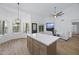 Kitchen island with white countertop, view to living room at 567 W Laredo Ave, Gilbert, AZ 85233