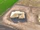 Aerial view of new home with roof installed surrounded by farmland at 7259 S 221St Ave, Buckeye, AZ 85326
