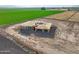 Aerial view of new construction home site with farmland, and mountain views at 7259 S 221St Ave, Buckeye, AZ 85326