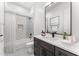 Charming bathroom with a tub-shower combo, gray-patterned tiles, a modern vanity, and soft lighting at 7259 S 221St Ave, Buckeye, AZ 85326