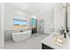Bright bathroom with a soaking tub, glass-enclosed shower, and double sink vanity with modern fixtures at 7259 S 221St Ave, Buckeye, AZ 85326