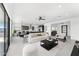 Bright open-concept living room with modern furniture, with a view of the kitchen and dining area at 7259 S 221St Ave, Buckeye, AZ 85326