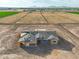Aerial view of new construction home with a gray roof, surrounded by open land and the potential for expansion at 7271 S 221St Ave, Buckeye, AZ 85326