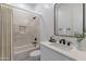 Well-lit bathroom boasts modern vanity with elegant fixtures, bathtub, and a shower, perfect for relaxation at 7271 S 221St Ave, Buckeye, AZ 85326