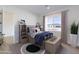 Comfortable bedroom with a full bed, stylish bedding and a large window with plenty of natural light at 7271 S 221St Ave, Buckeye, AZ 85326