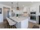 Modern kitchen featuring a large island with seating, stainless steel appliances, and pendant lighting at 7271 S 221St Ave, Buckeye, AZ 85326