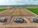 Aerial view of a home under construction with a backdrop of farmland and mountains at 7283 S 221St Ave, Buckeye, AZ 85326