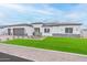 Beautiful single story home with well maintained lawn with a two-car garage and neutral paint at 7295 S 221St Ave, Buckeye, AZ 85326