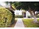 Exterior view of lush landscaping leading to the front door at 7740 E Heatherbrae Ave # 5, Scottsdale, AZ 85251